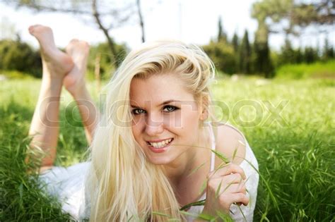 Beautiful girl lying down of grass | Stock image | Colourbox