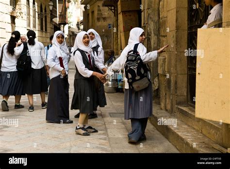 Egyptian school girls wearing school uniform in one of Cairo's old neighborhoods Stock Photo - Alamy