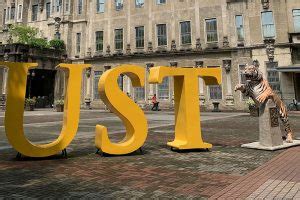 New UST tiger statue becomes 'wishing well' during students' prelims week