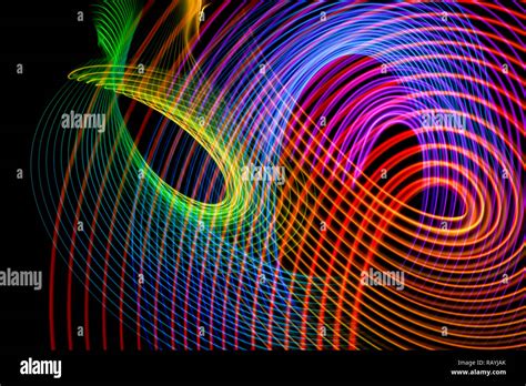 Abstract light blue, orange, green, pink and purple trails in random motion background image ...
