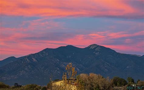 Beautiful sunset over the Taos Mountain Photograph by Elijah Rael