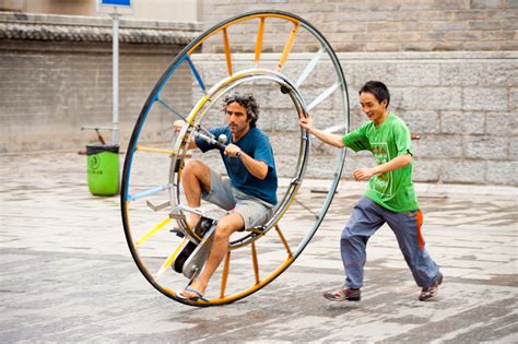 Single Wheeled Bicycle - An Italian tourist attempts to ride, with assistance, a unique, single ...