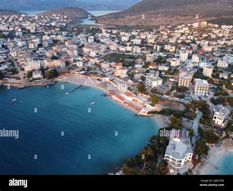 A drone view of a small town with buildings and a sandy beach near a sea shore with boats Stock ...