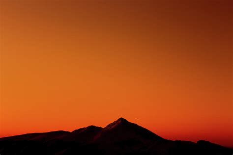 Orange Sunset Sky And Snowy Mountains Photograph by Cavan Images ...