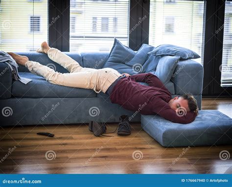 Drunk Man Resting on Couch with Head on the Floor Stock Photo - Image of inside, adult: 176667940