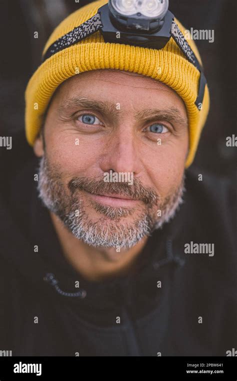 Portrait of a man climber in a hat with a flashlight on his head Stock Photo - Alamy
