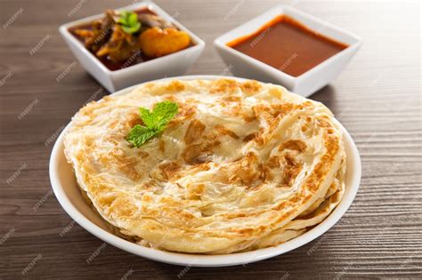 Premium Photo | Roti parata or roti canai with lamb curry sauce