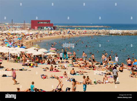 Tourists sunbathing on Platja Nova Icaria ( Nova Icaria Beach ), Port ...