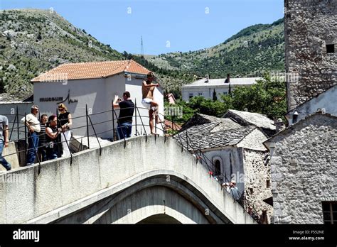 Young Man jumping from Old Bridge in Mostar Stock Photo - Alamy