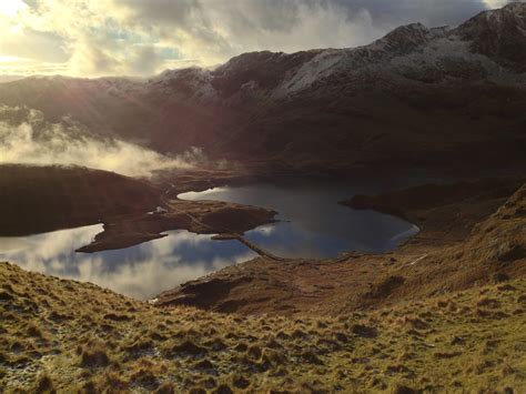 a bridge over a river in a mountain valley in snowdonia, snowdonia ...