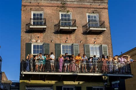 People Standing on a Balcony Having Drinks on Bourbon Street with ...