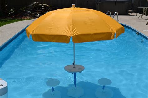 swimming pool tabe with umbrella and chairs Aqua Party Bar | Pool ...