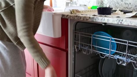 A Woman Unloading The Dishwasher In The Kitchen Stock Footage Video 6013547 - Shutterstock