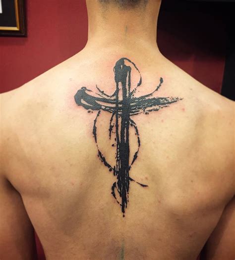 Beautiful black cross tattoo on back - Tattooimages.biz