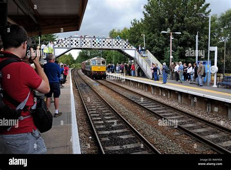 Railway enthusiasts photographing a railway excursion train at ...