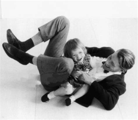 a black and white photo of two people laying on the floor with text ...