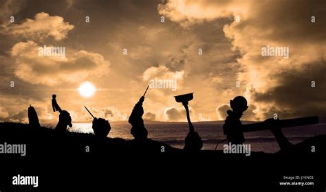 Digital composite of Silhouette hands holding tools at beach during ...