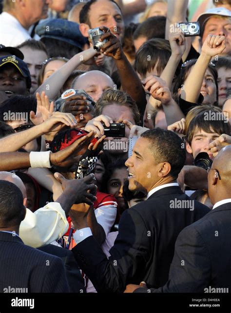 Democratic US presidential contender Barack Obama shakes hands with people from the audience ...