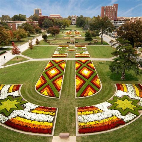 an aerial view of a flower garden in the middle of a campus