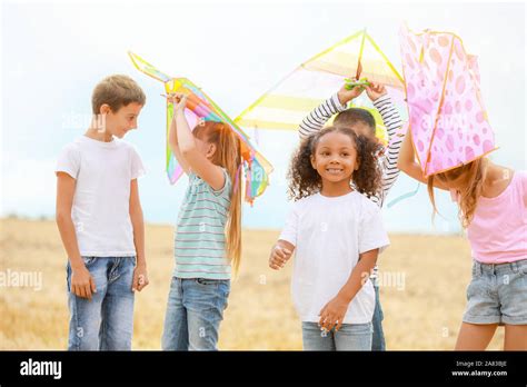 Little children flying kites outdoors Stock Photo - Alamy