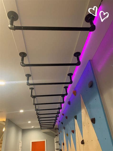 an indoor climbing wall with purple lights