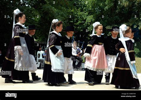 Wearing traditional costumes, Breton youngsters perform a folk dance ...