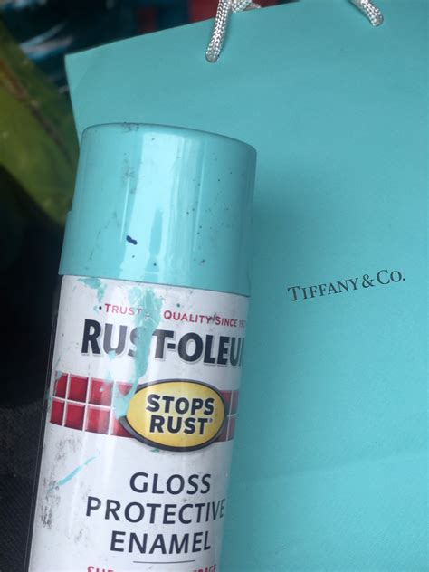 a blue spray can sitting on top of a table next to a paper bag and scissors