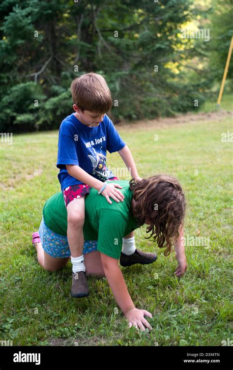 Children playing horse, boy on his sister Stock Photo - Alamy