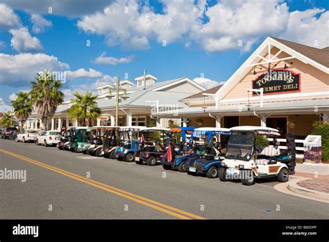 Golf carts parked along downtown street in The Villages retirement ...