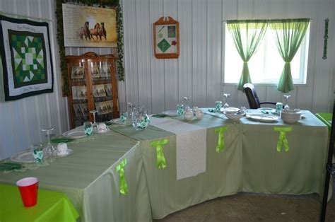 the table is set up with green and white linens for an elegant dinner party