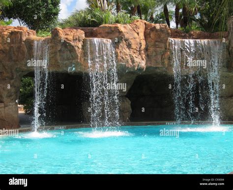 several outdoor waterfalls by an inground swimming pool Stock Photo - Alamy