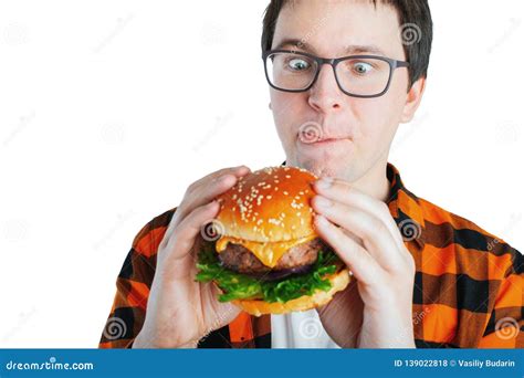 Young Man Holding a Piece of Hamburger. Student Eats Fast Food. Burger is Not Helpful Food Stock ...