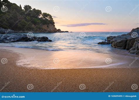 Sunrise on a sandy beach stock image. Image of water - 169699495