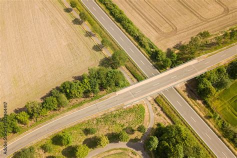 Aerial view of bridge crossing road Stock Photo | Adobe Stock