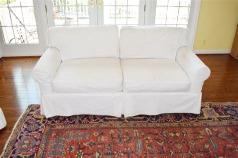 An Arhaus Two Cushion Sofa with White Canvas Slipcover | EBTH