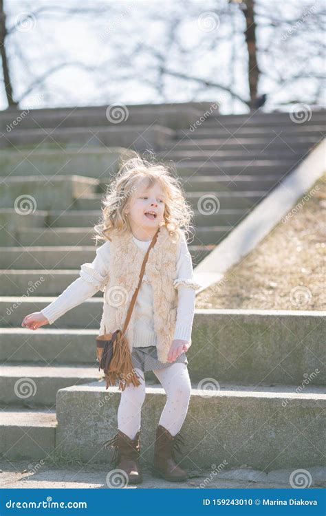 Little Girl Walking Alone in the City Park and Enjoy. Stock Photo ...