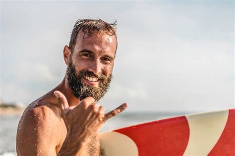 Premium Photo | Surfer happy with surf surfing smiling doing hawaiian shaka brah or hang loose