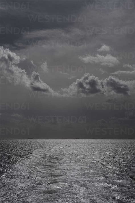 Black and white storm clouds over ocean stock photo