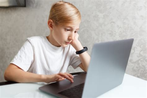 Premium Photo | A child with a laptop performs homework for online training