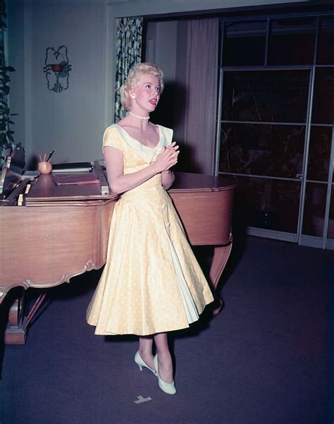 (Original Caption) Doris Day in a yellow dress, singing in front of a ...