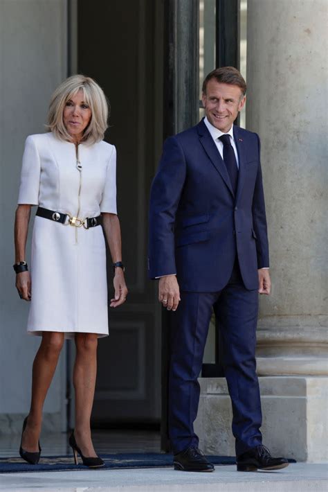 Brigitte Macron Favors Utilitarian Details in White Louis Vuitton Dress ...