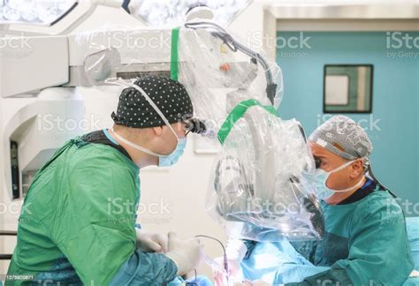 Male Neurosurgeon Team Operating Brain Tumor Surgery In Hospital ...