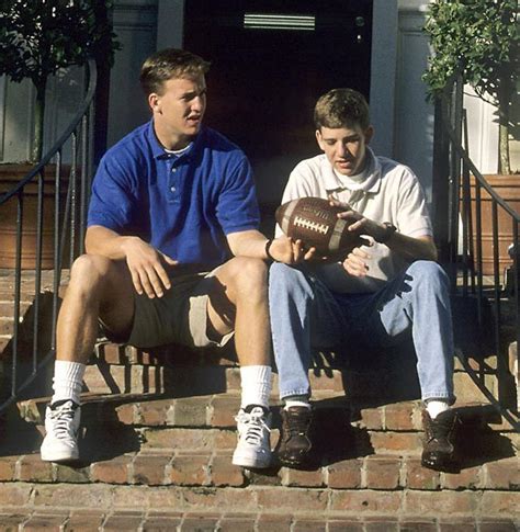 Peyton Manning gives his little brother Eli some... - SI Photo Blog