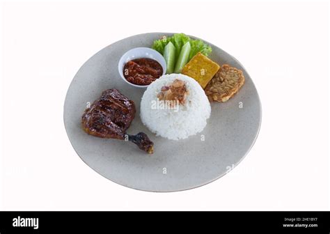 Pecel Ayam or Ayam Penyet is a traditional Indonesian fried chicken with fresh vegetables, chili ...