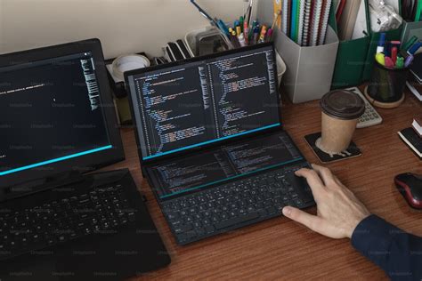 A person typing on a laptop on a desk photo – Coding Image on Unsplash