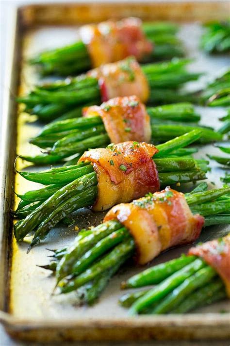 A row of green bean bundles on a pan. | Thanksgiving recipes side dishes, Thanksgiving food ...