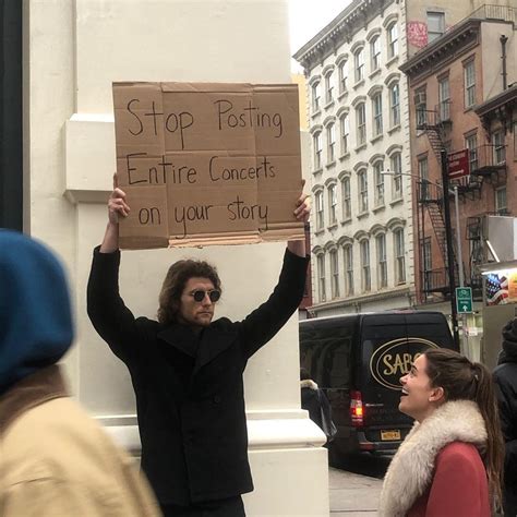 'Dude With Sign' Holds Up Random Protest Signs With Declarations That May Not Seem Relevant at ...