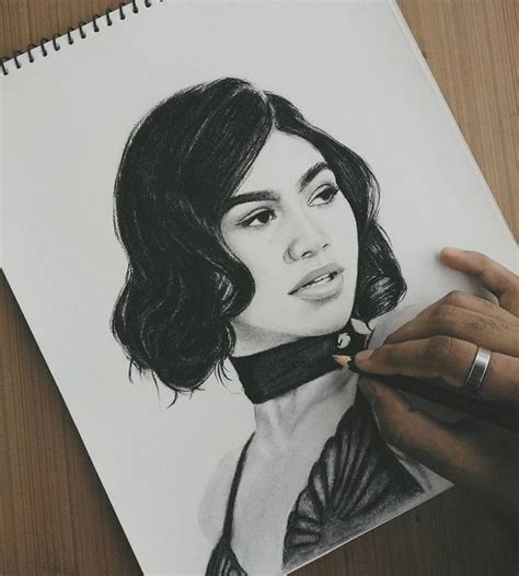 a drawing of a woman's face is being drawn by someone with a pencil