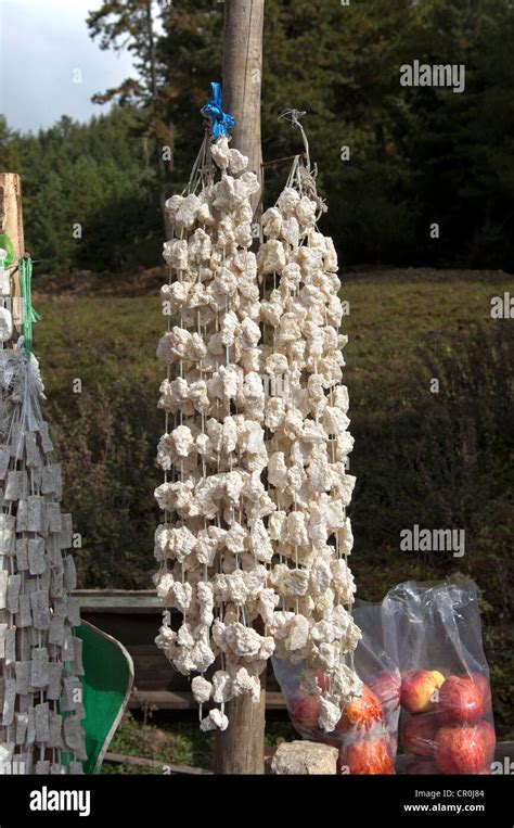 Bhutanese Churpi or Chugui snack, made of dried cheese, at a market stall, Bhutan, South Asia ...