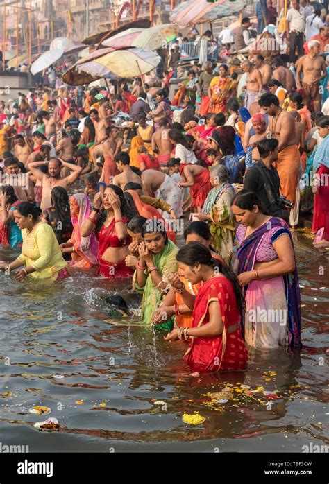 Hindu believers bath and perform ritual bath and puja prayers at ghats ...